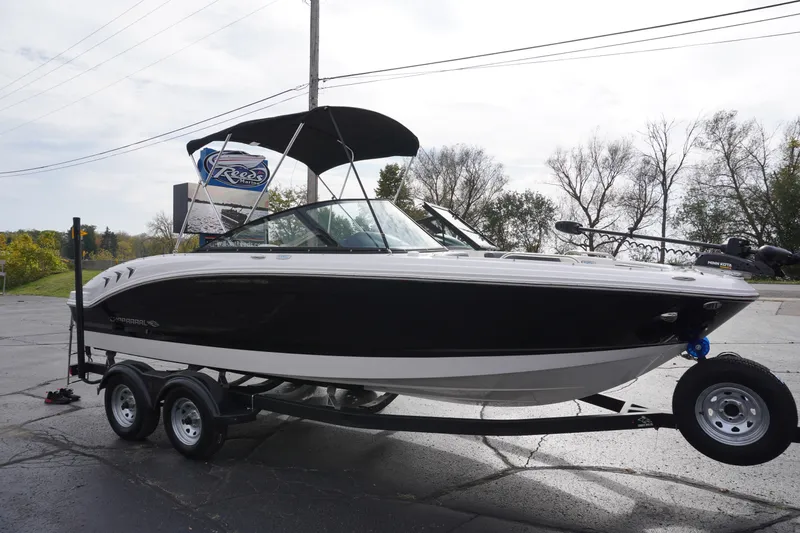Slide: The Image of 2026 Chaparral 21 SSi Ski & Fish boat on trailer, black and white design. - 4