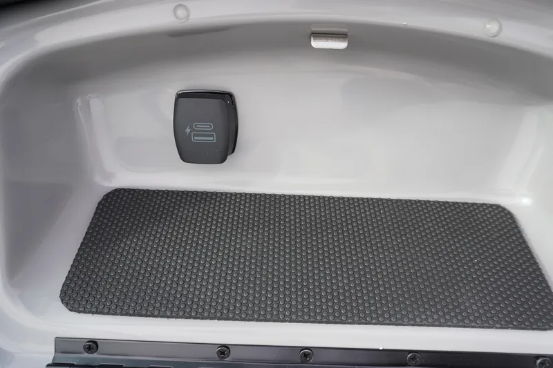 Slide: The Image of Storage compartment in 2026 Chaparral 21 SSi Ski & Fish boat with power outlet. - 41