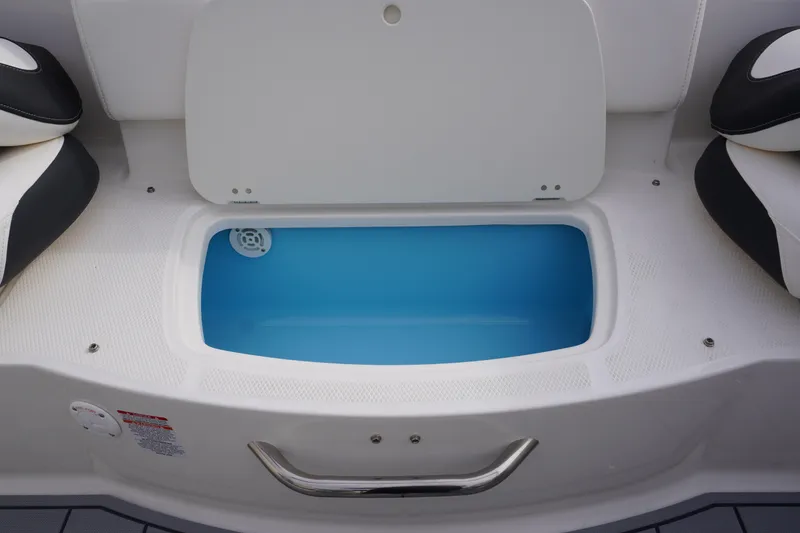 Slide: The Image of 2026 Chaparral 21 SSi Ski & Fish boat livewell with open lid and blue interior. - 51