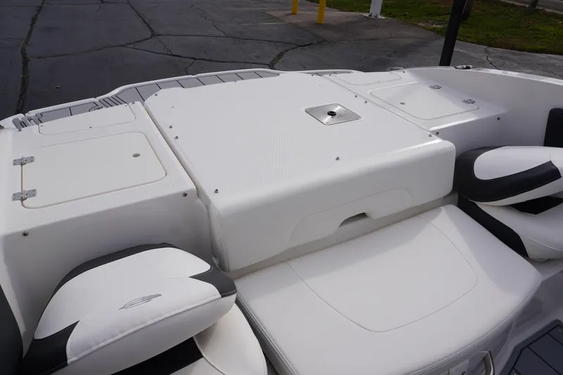 Slide: The Image of 2026 Chaparral 21 SSi Ski & Fish boat interior with white seating and storage compartments. - 55