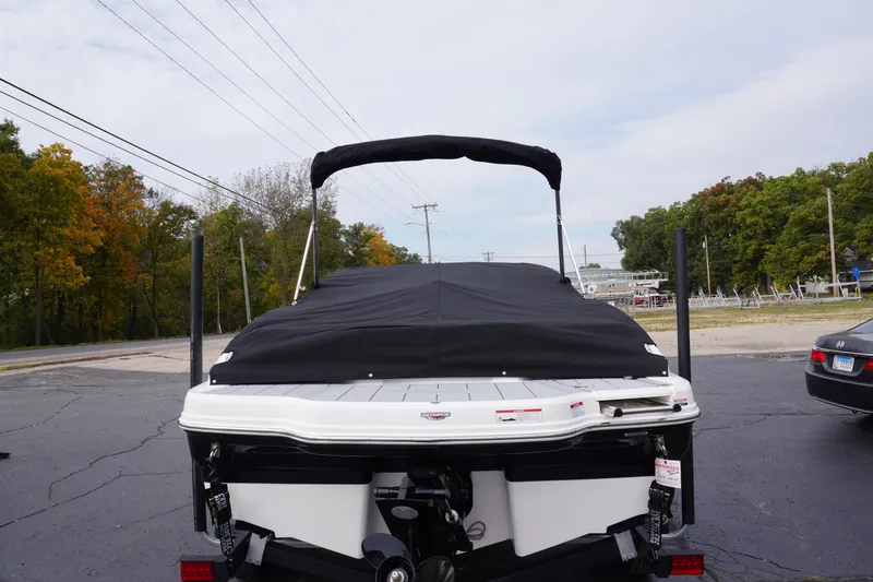 Slide: The Image of 2026 Chaparral 21 SSi Ski & Fish boat with cover, parked outdoors. - 61