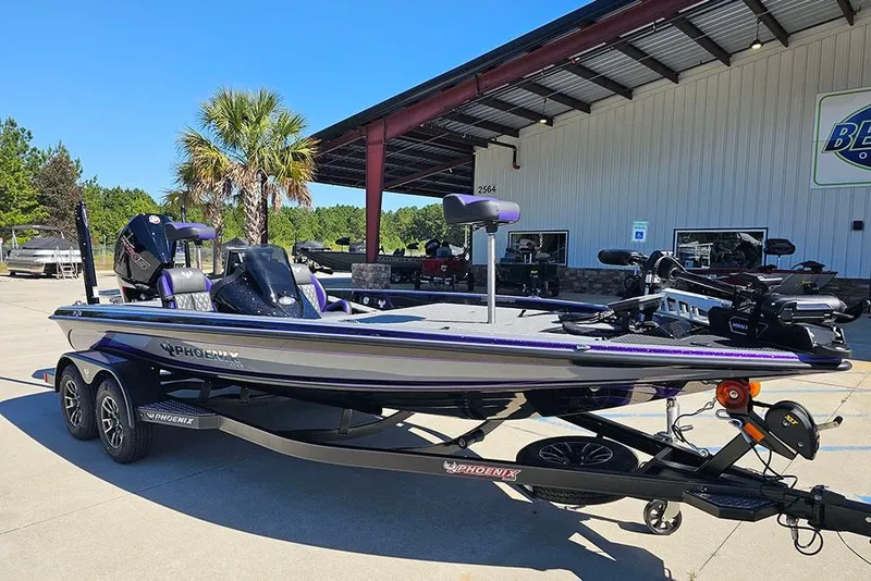 Slide: The Image of 2026 Phoenix 721 ZXL boat on trailer, parked outdoors near a building. - 10