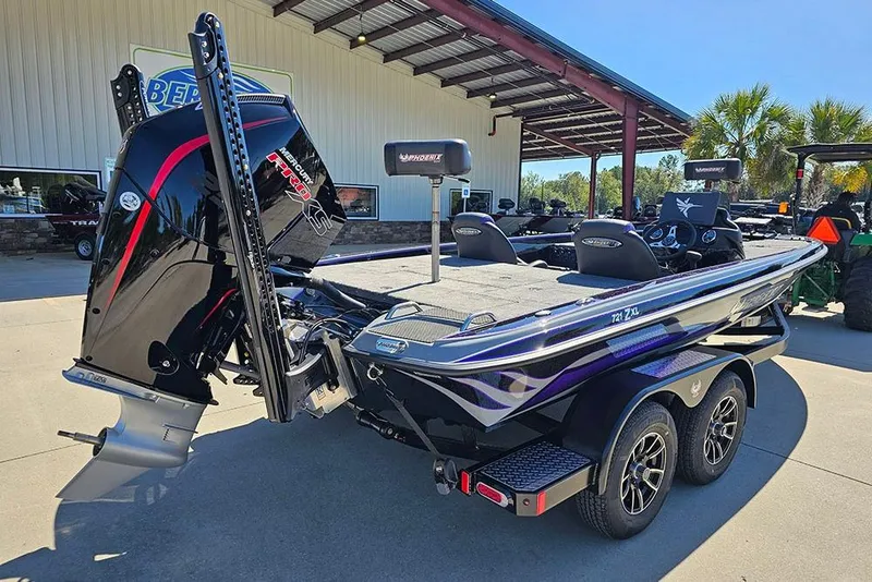 Slide: The Image of 2026 Phoenix 721 ZXL boat with Mercury engine, parked outdoors under a canopy. - 11