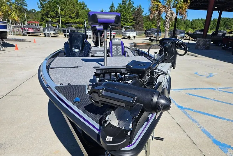 Slide: The Image of 2026 Phoenix 721 ZXL bass boat with advanced trolling motor in a marina setting. - 12