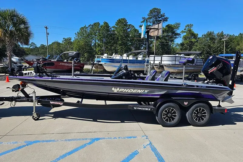 Slide: The Image of 2026 Phoenix 721 ZXL bass boat on trailer, parked outdoors under clear blue sky. - 14