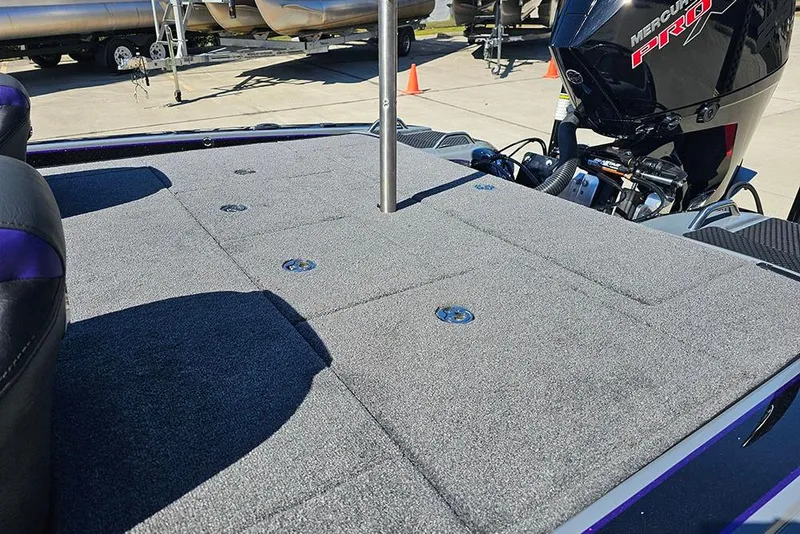 Slide: The Image of 2026 Phoenix 721 ZXL boat deck with Mercury Pro engine, featuring carpeted surface and storage compartments. - 18