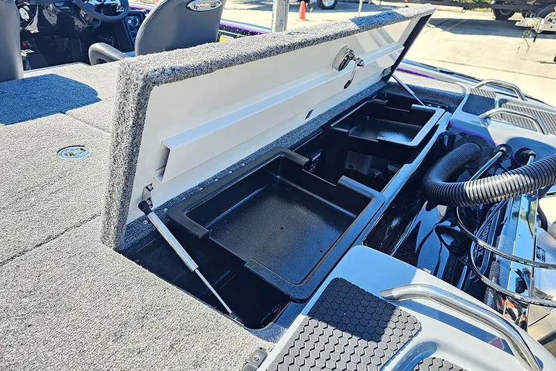 Slide: The Image of 2026 Phoenix 721 ZXL boat storage compartment with open lid and interior trays. - 19