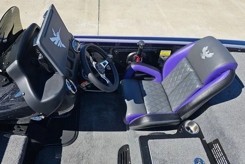 Slide: The Image of 2026 Phoenix 721 ZXL boat interior with steering wheel and purple-accented seat. - 22