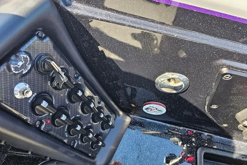Slide: The Image of Dashboard controls of a 2026 Phoenix 721 ZXL boat, featuring switches and key ignition. - 25