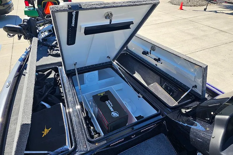 Slide: The Image of Open storage compartments in 2026 Phoenix 721 ZXL boat, showcasing interior features and equipment. - 31