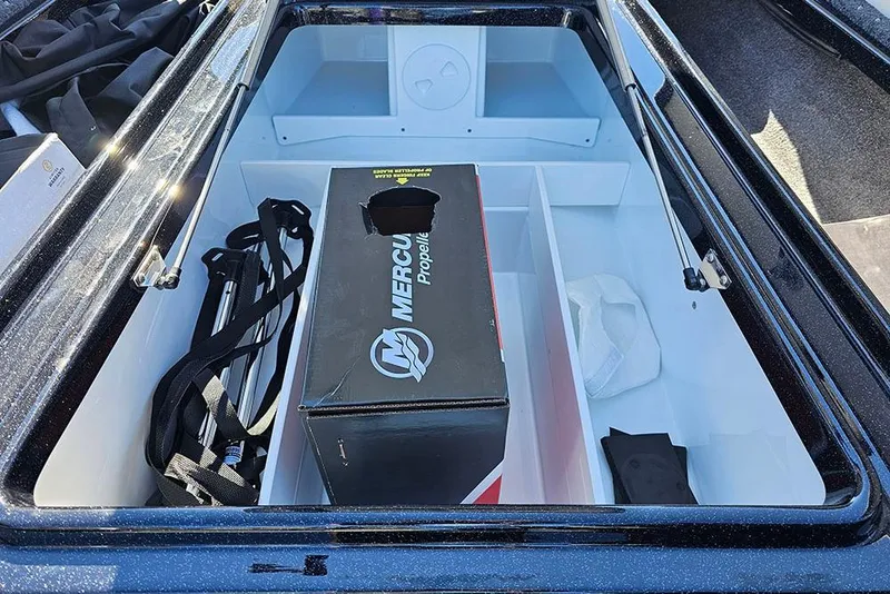 Slide: The Image of Open storage compartment in 2026 Phoenix 721 ZXL boat with Mercury propeller box. - 32