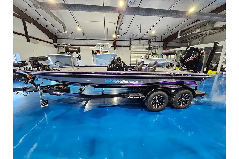 Slide: The Image of 2026 Phoenix 721 ZXL bass boat in showroom, featuring sleek design and modern equipment. - 6
