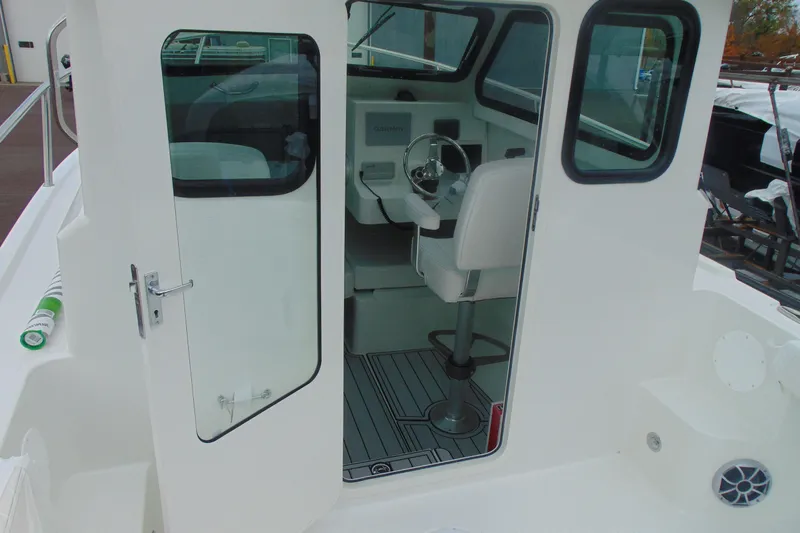 Slide: The Image of 2026 Parker 227 Explorer boat interior with steering wheel and seating. - 10