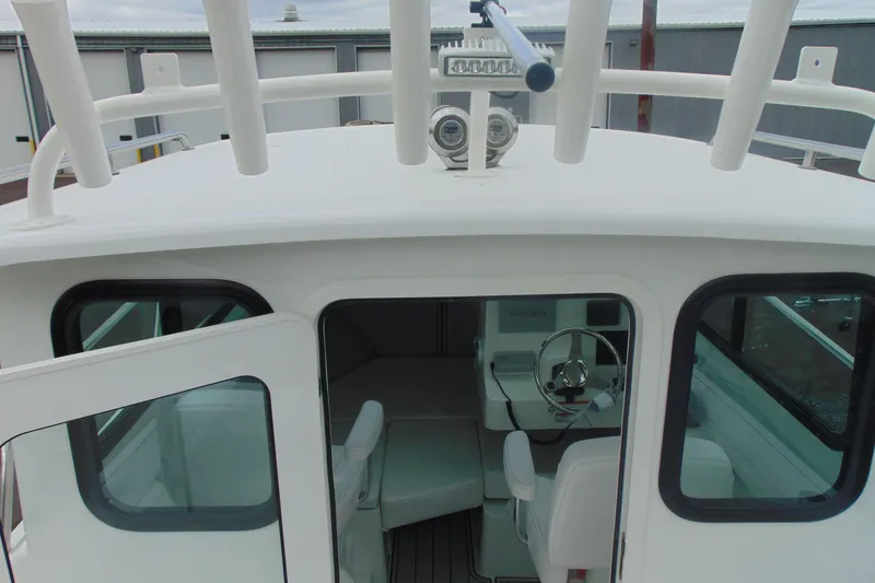 Slide: The Image of 2026 Parker 227 Explorer boat interior with steering wheel and seating. - 11