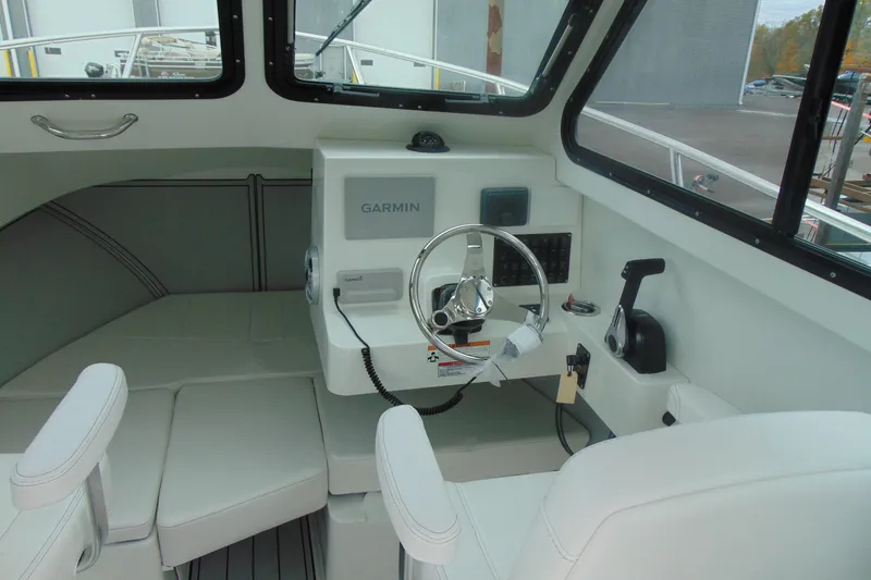 Slide: The Image of Interior of 2026 Parker 227 Explorer boat with Garmin navigation system and steering wheel. - 12