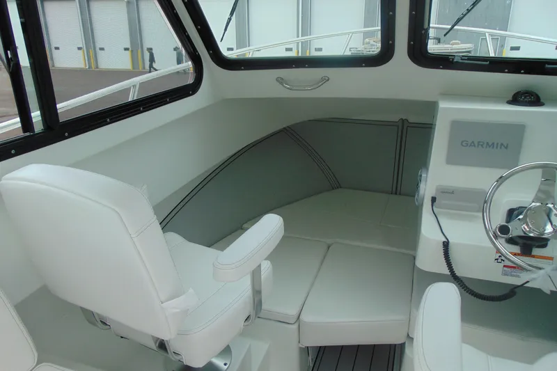 Slide: The Image of Interior of 2026 Parker 227 Explorer boat with Garmin navigation system and white seating. - 13