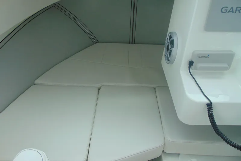 Slide: The Image of Interior cabin of 2026 Parker 227 Explorer boat with cushioned seating and Garmin device. - 16