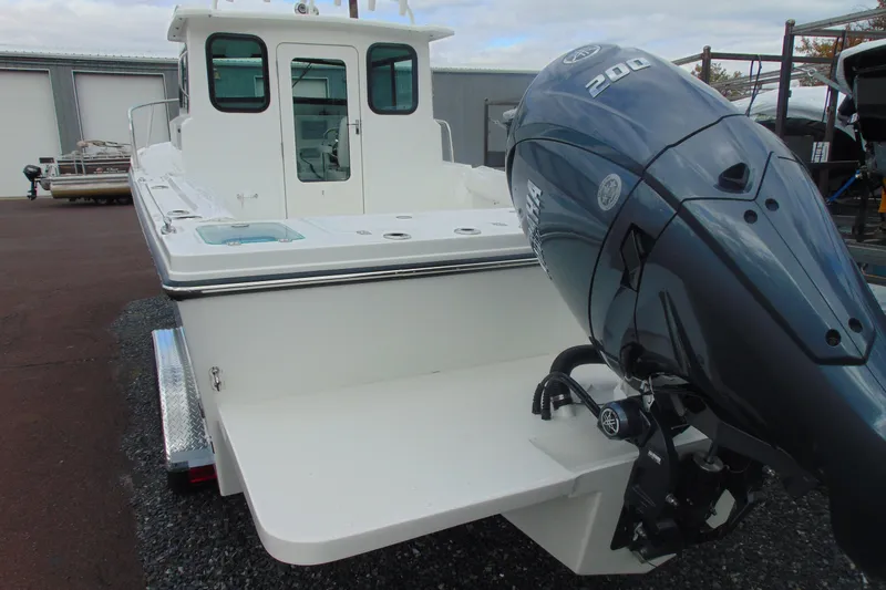 Slide: The Image of 2026 Parker 227 Explorer boat with Yamaha 200 outboard motor, docked outdoors. - 3