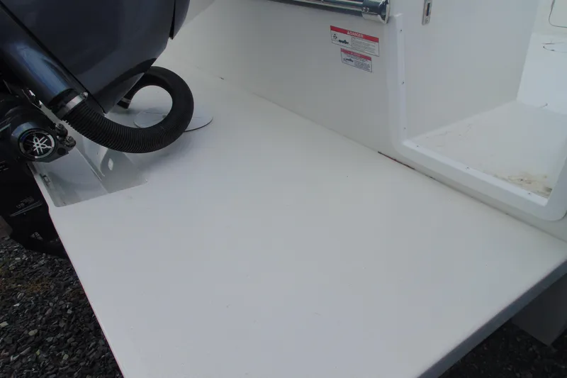 Slide: The Image of 2026 Parker 227 Explorer boat engine area with white deck and motor components. - 4