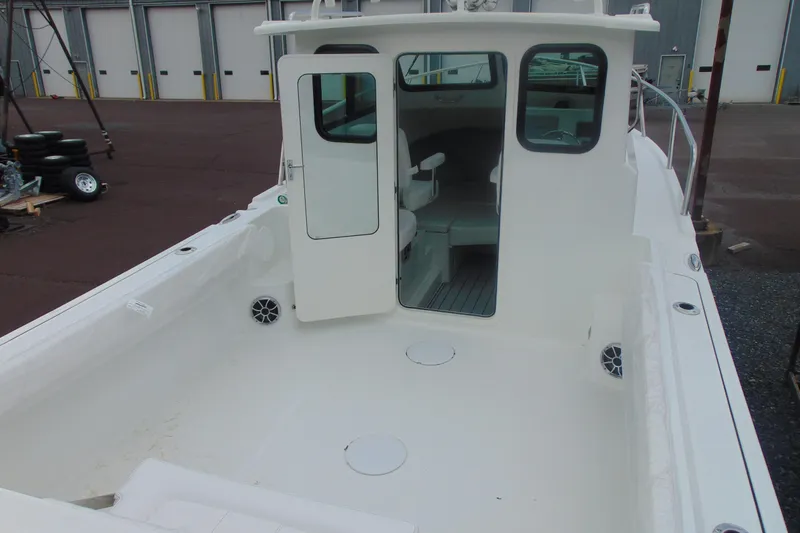 Slide: The Image of 2026 Parker 227 Explorer boat with open cabin door, spacious deck, and seating area. - 6