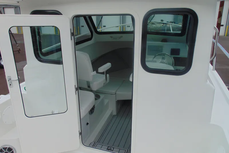 Slide: The Image of Interior view of 2026 Parker 227 Explorer boat with seating and helm. - 7
