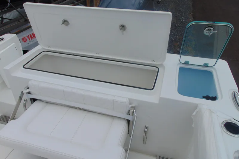 Slide: The Image of 2026 Parker 227 Explorer boat interior with open storage compartments and seating. - 9