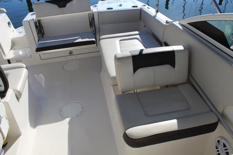 Slide: The Image of 2024 Sailfish 226DC boat interior with cushioned seating and sleek design. - 14