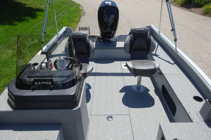 Slide: The Image of 2024 Lund 1675 Alaskan SS boat interior with seating and steering console. - 11