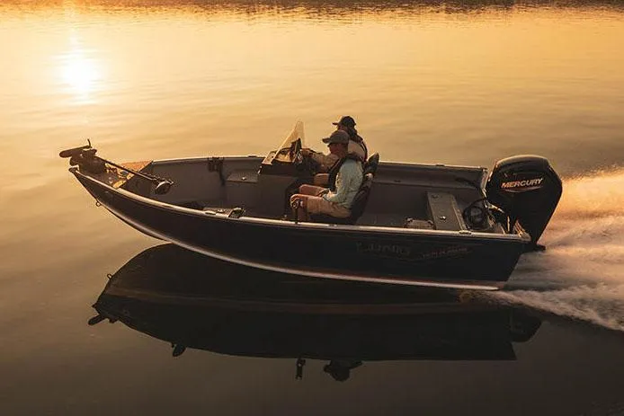 Slide: The Image of Manufacturer Provided Image: 2024 Lund 1675 Alaskan SS boat cruising on calm water at sunset. - 14