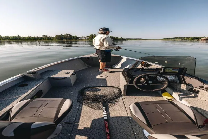 Slide: The Image of Manufacturer Provided Image: Man fishing on a 2024 Lund 1675 Alaskan SS boat in a calm lake. - 16