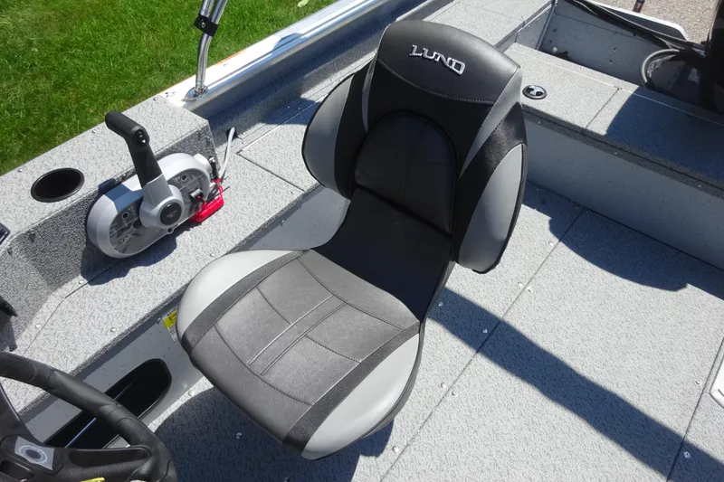 Slide: The Image of 2024 Lund 1675 Alaskan SS boat interior with steering and seating detail. - 4