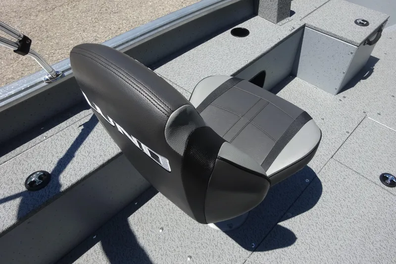 Slide: The Image of 2024 Lund 1675 Alaskan SS boat seat, gray and black design, on textured deck. - 5
