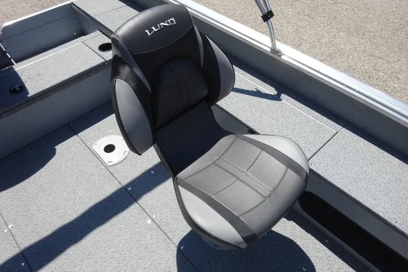 Slide: The Image of 2024 Lund 1675 Alaskan SS boat seat, gray and black design, on deck. - 6