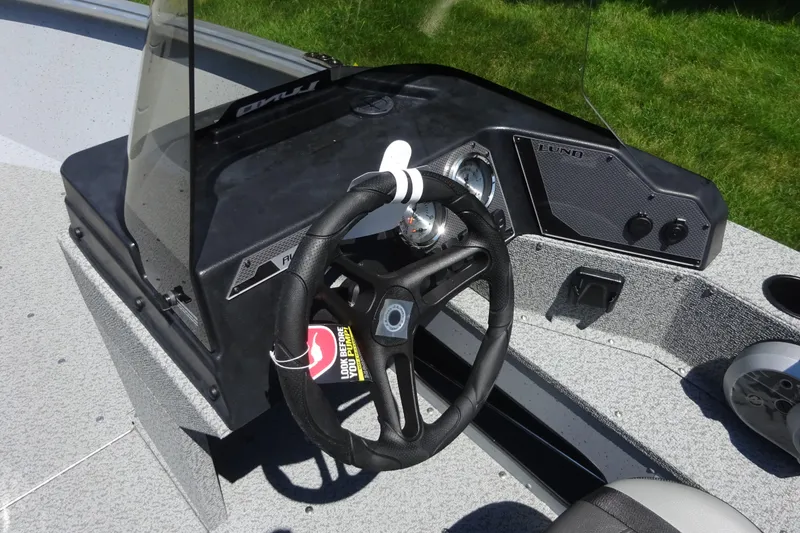 Slide: The Image of 2024 Lund 1675 Alaskan SS boat dashboard with steering wheel and gauges. - 9