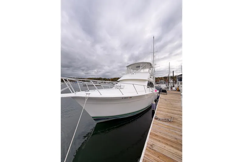 Slide: The Image of 2001 Egg Harbor 42 SportYacht docked at marina under cloudy skies. - 13
