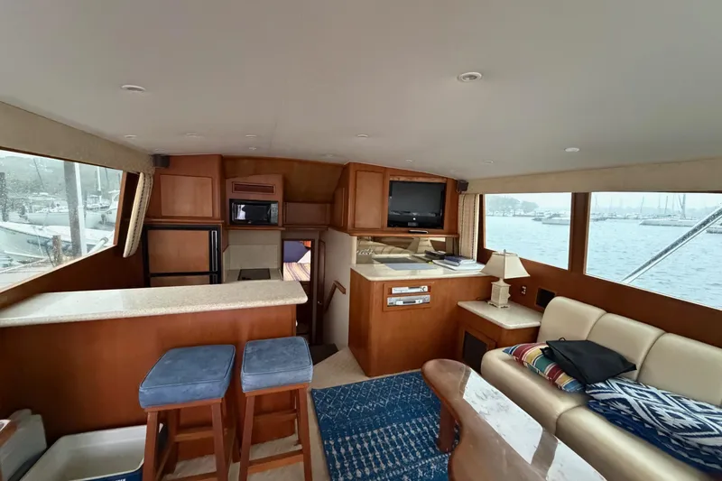 Slide: The Image of Interior of 2001 Egg Harbor 42 SportYacht with seating, bar stools, and waterfront view. - 15