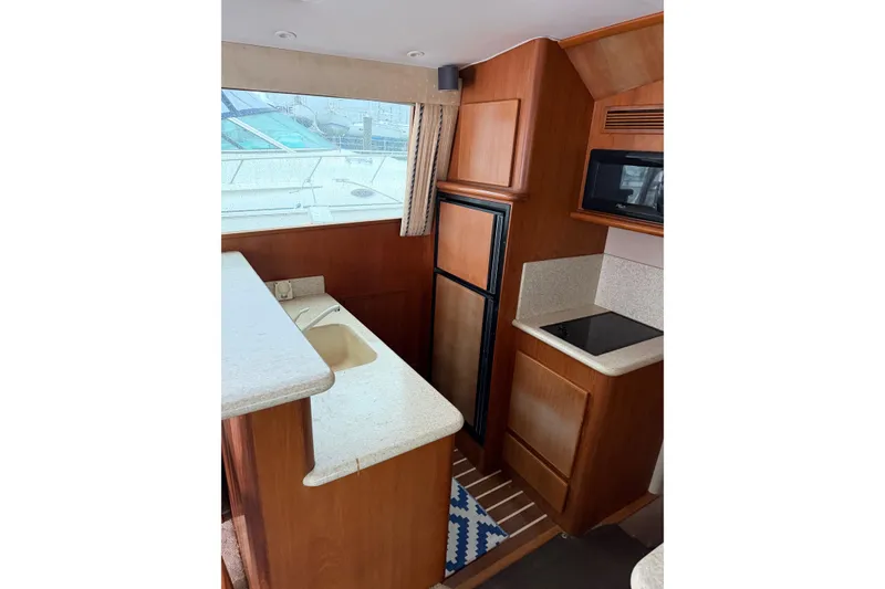 Slide: The Image of Interior of 2001 Egg Harbor 42 SportYacht kitchen with sink, stove, and microwave. - 22