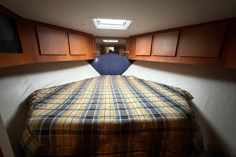 Slide: The Image of Cozy cabin interior of 2001 Egg Harbor 42 SportYacht with plaid bedding. - 25