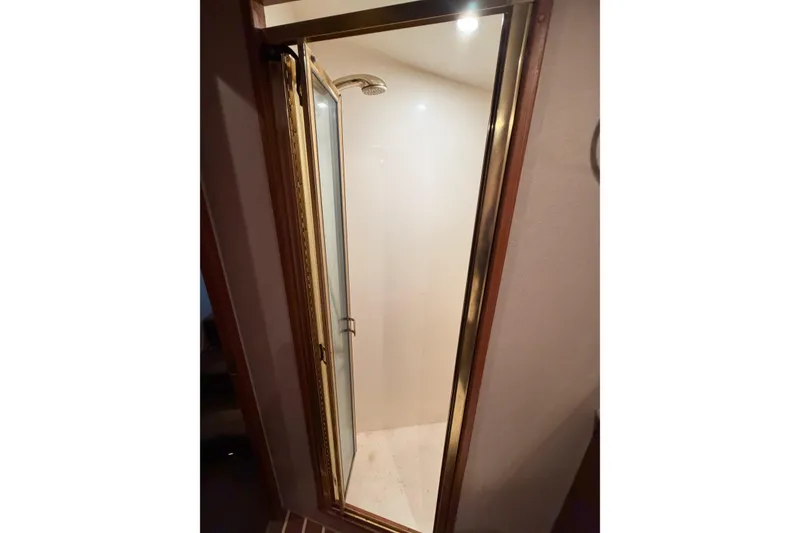 Slide: The Image of Shower area inside 2001 Egg Harbor 42 SportYacht with glass door and gold trim. - 31
