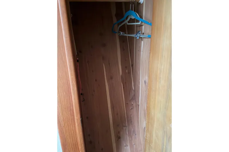 Slide: The Image of Wooden closet interior with hangers, inside a 2001 Egg Harbor 42 SportYacht. - 32