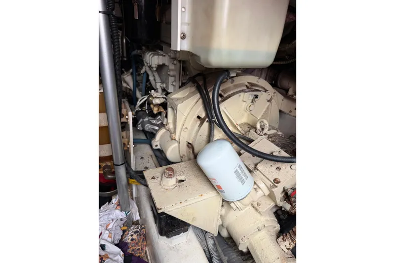 Slide: The Image of Engine compartment of a 2001 Egg Harbor 42 SportYacht, showing mechanical components and hoses. - 36