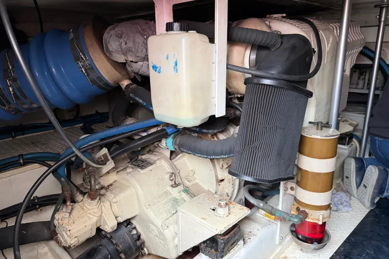 Slide: The Image of Engine room of a 2001 Egg Harbor 42 SportYacht, showcasing mechanical components. - 38