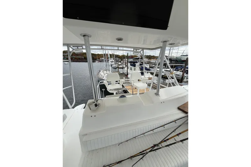 Slide: The Image of 2001 Egg Harbor 42 SportYacht, view of cockpit and seating area at marina. - 6