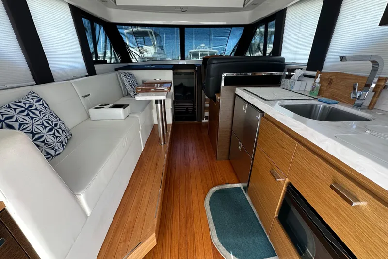 Slide: The Image of Interior of 2018 Tiara Yachts C39 Coupe with modern kitchen and seating area. - 10