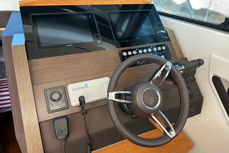 Slide: The Image of 2018 Tiara Yachts C39 Coupe helm with Garmin displays and steering wheel. - 11