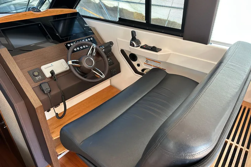 Slide: The Image of 2018 Tiara Yachts C39 Coupe helm with leather seating and advanced navigation controls. - 12