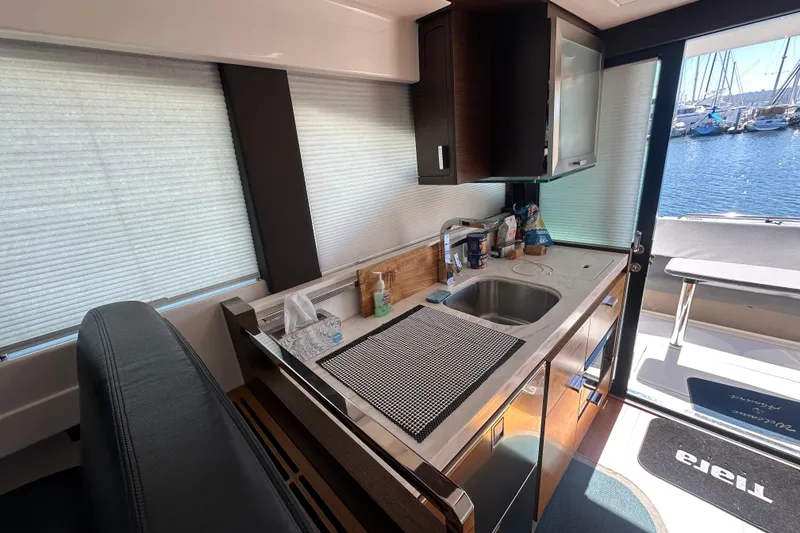 Slide: The Image of Modern kitchen interior of 2018 Tiara Yachts C39 Coupe with marina view. - 14