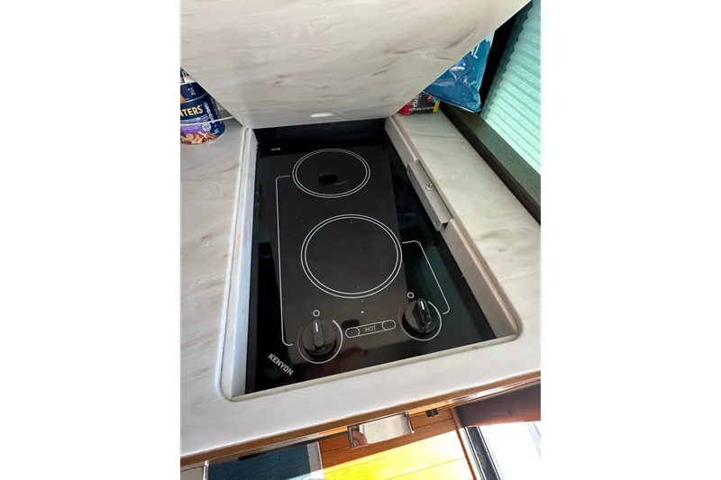 Slide: The Image of 2018 Tiara Yachts C39 Coupe kitchen with Kenyon electric cooktop. - 17