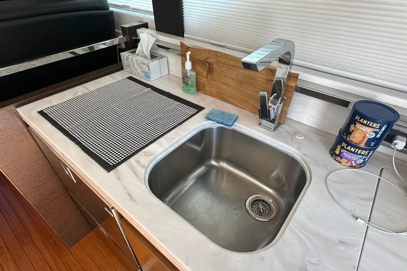 Slide: The Image of 2018 Tiara Yachts C39 Coupe kitchen sink with countertop, faucet, and snacks. - 18