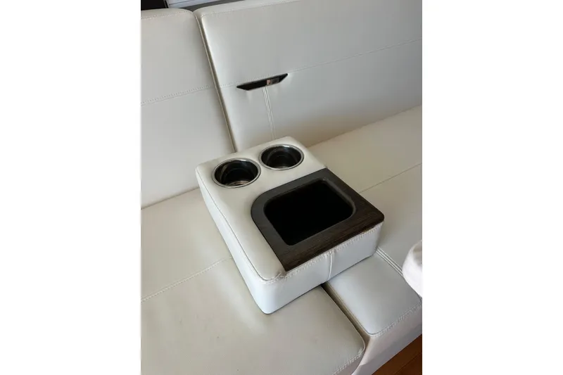 Slide: The Image of White leather seating with cup holders on a 2018 Tiara Yachts C39 Coupe. - 21